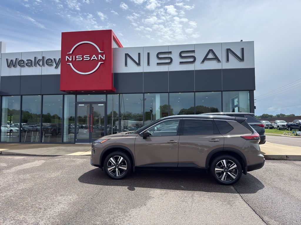 2025 Nissan Rogue SL in 2T Dk Beig — front three-quarter view